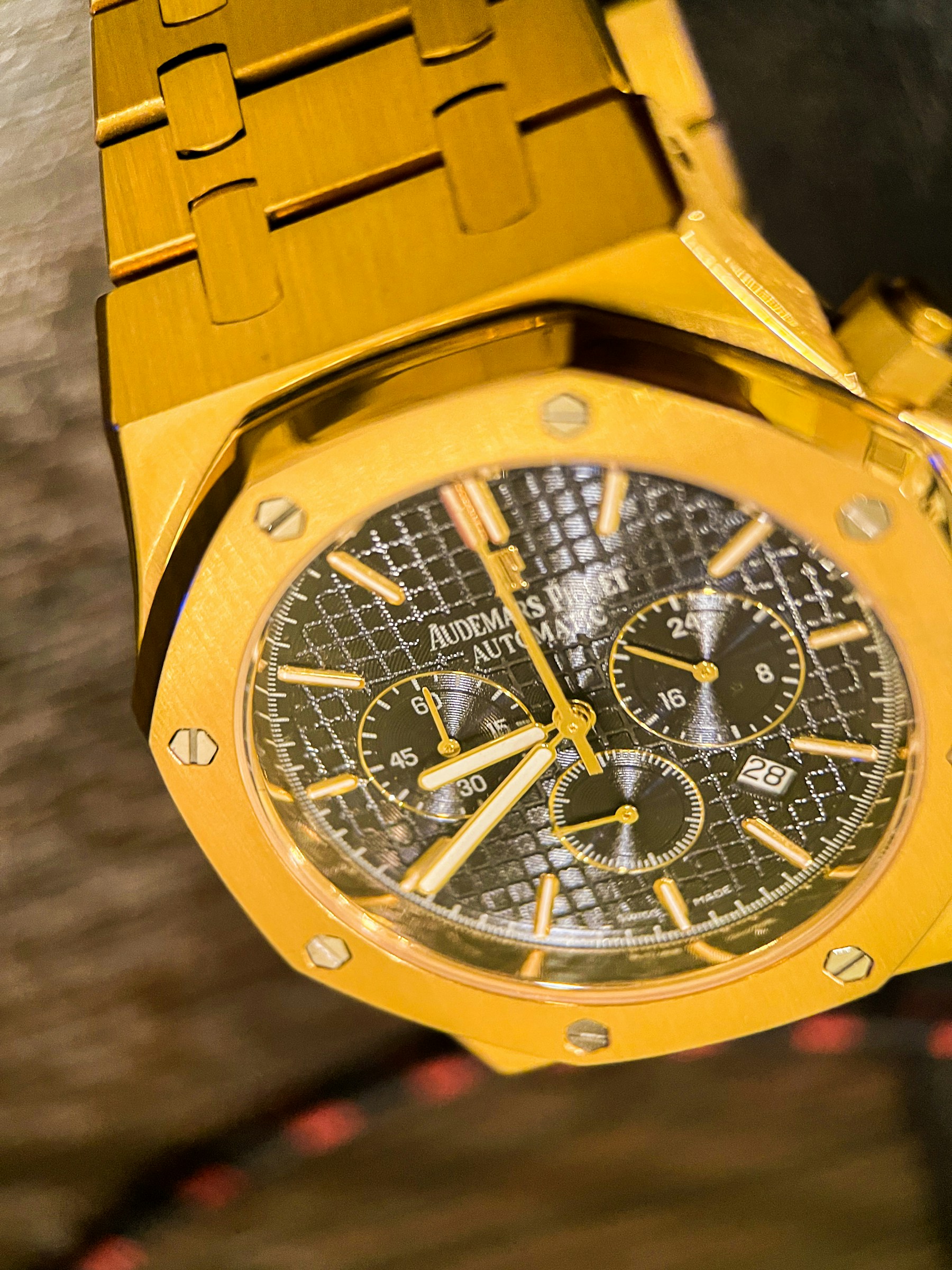 A gold Audemars Piguet chronograph with an intricate black dial